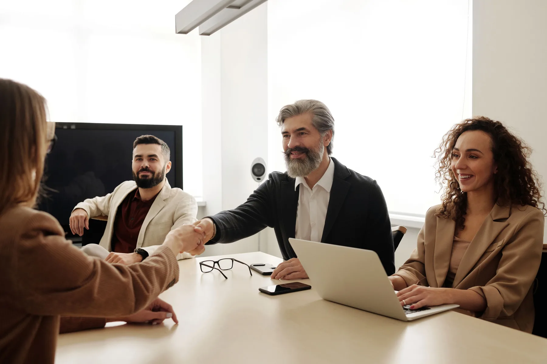 Business leaders greeting a candidate in a meeting